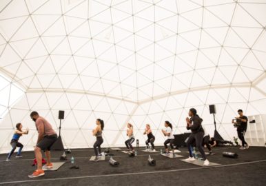 Geodesic dome with people doing a workout routine for an Adidas event